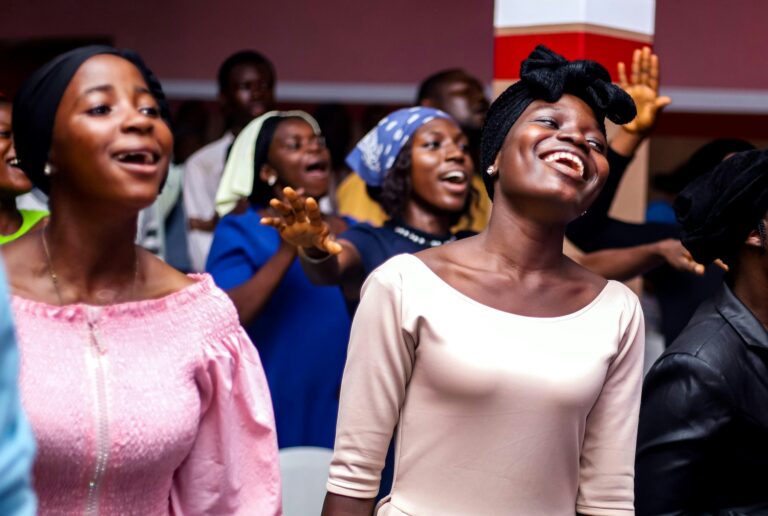 Joyful women worshipping in church